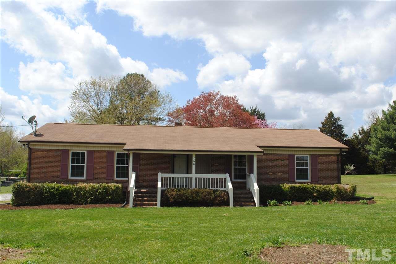 754 Abbott Road Henderson, NC 27537 - Photo 1 of 12 front view of a house and a yard