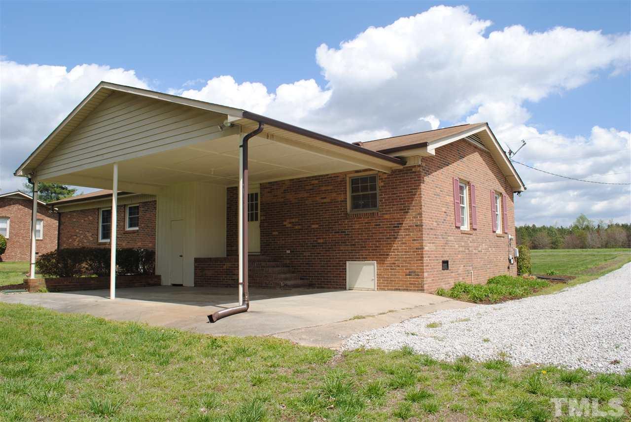 754 Abbott Road Henderson, NC 27537 - Photo 3 of 12 a front view of a house with a yard and garage