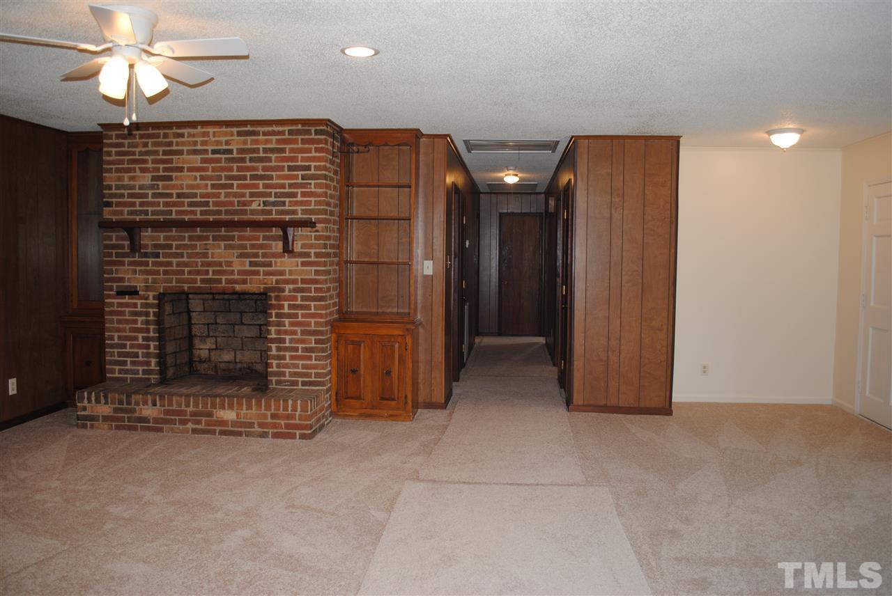 754 Abbott Road Henderson, NC 27537 - Photo 7 of 12 a view of an empty room with a fireplace