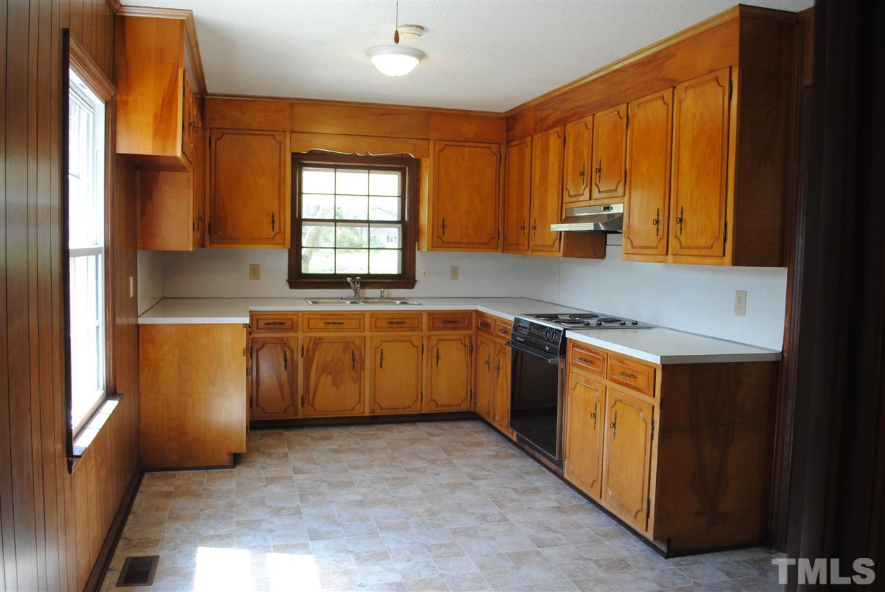 754 Abbott Road Henderson, NC 27537 - Photo 8 of 12 a kitchen with stainless steel appliances a sink stove and window