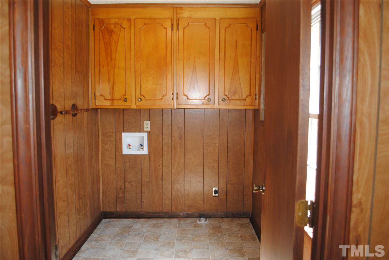 754 Abbott Road Henderson, NC 27537 - Photo 9 of 12 an empty room with wooden door