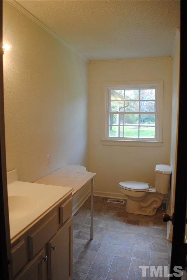 754 Abbott Road Henderson, NC 27537 - Photo 10 of 12 a bathroom with a sink toilet and window