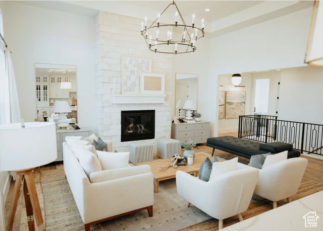 1577 North 1350 E Street, Unit 1 Mapleton, UT 84664 - Photo 2 of 15 Living area with a high ceiling, a chandelier, a fireplace, and wood finished floors