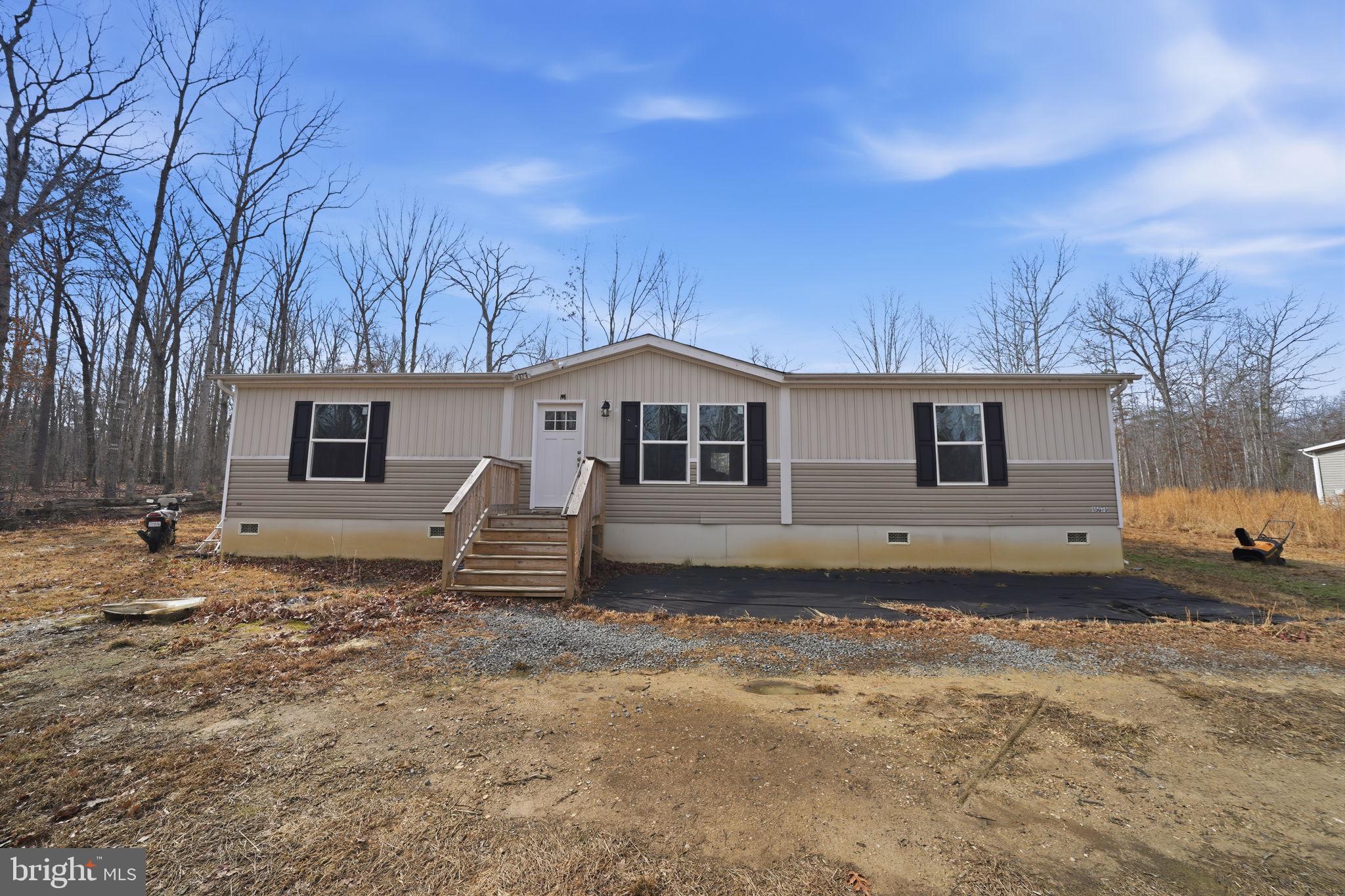 a view of a house with a yard covered in snow