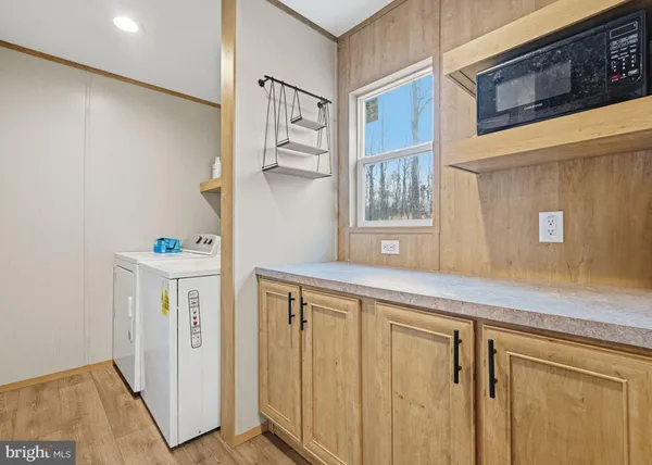 a hallway with cabinets a sink and a window