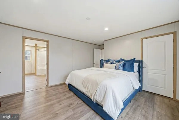 a bedroom with bed and cabinets