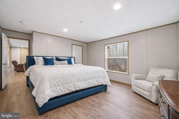 a bedroom with a large bed and a couch