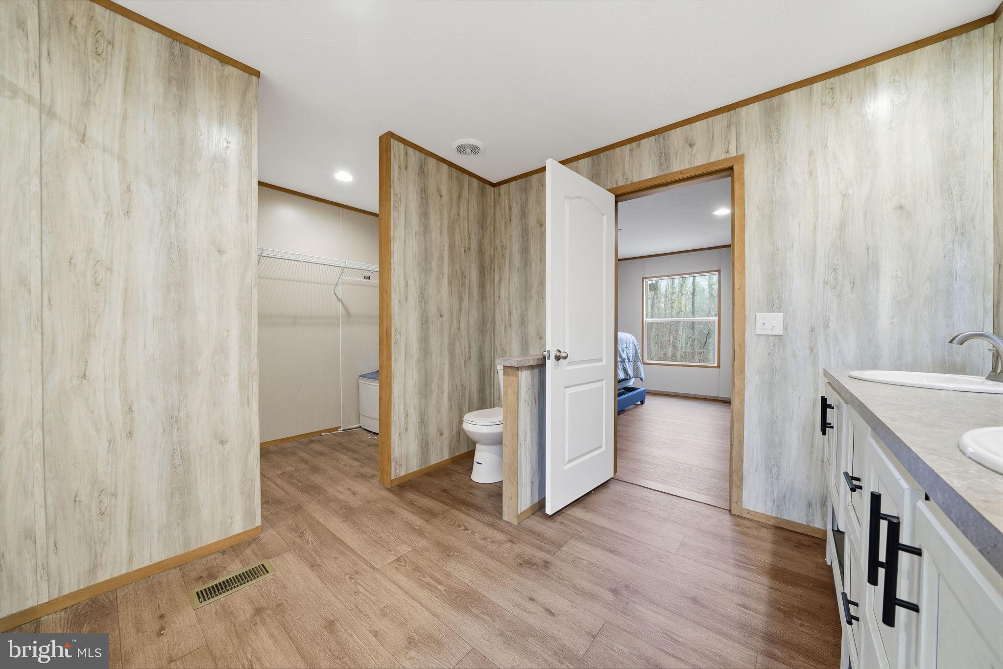 15075 Madison Run Road Gordonsville, VA 22942 - Photo 16 of 23 a view of a hallway with wooden floor and a bathroom