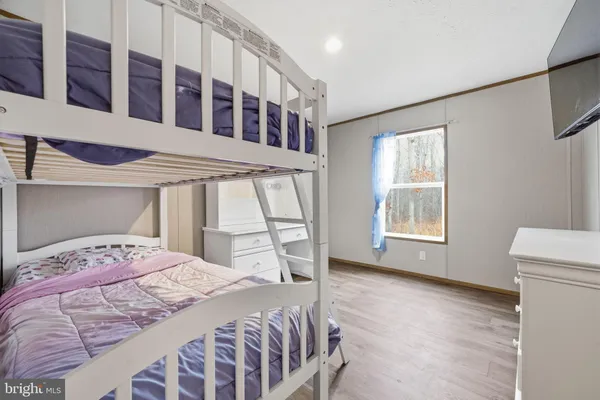 a bedroom with a bed next to a window