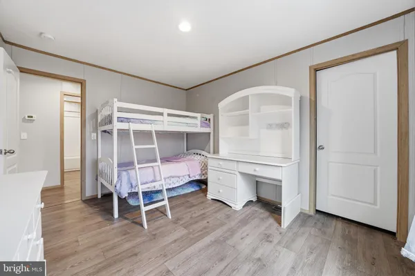 a room with wooden floor and white walls