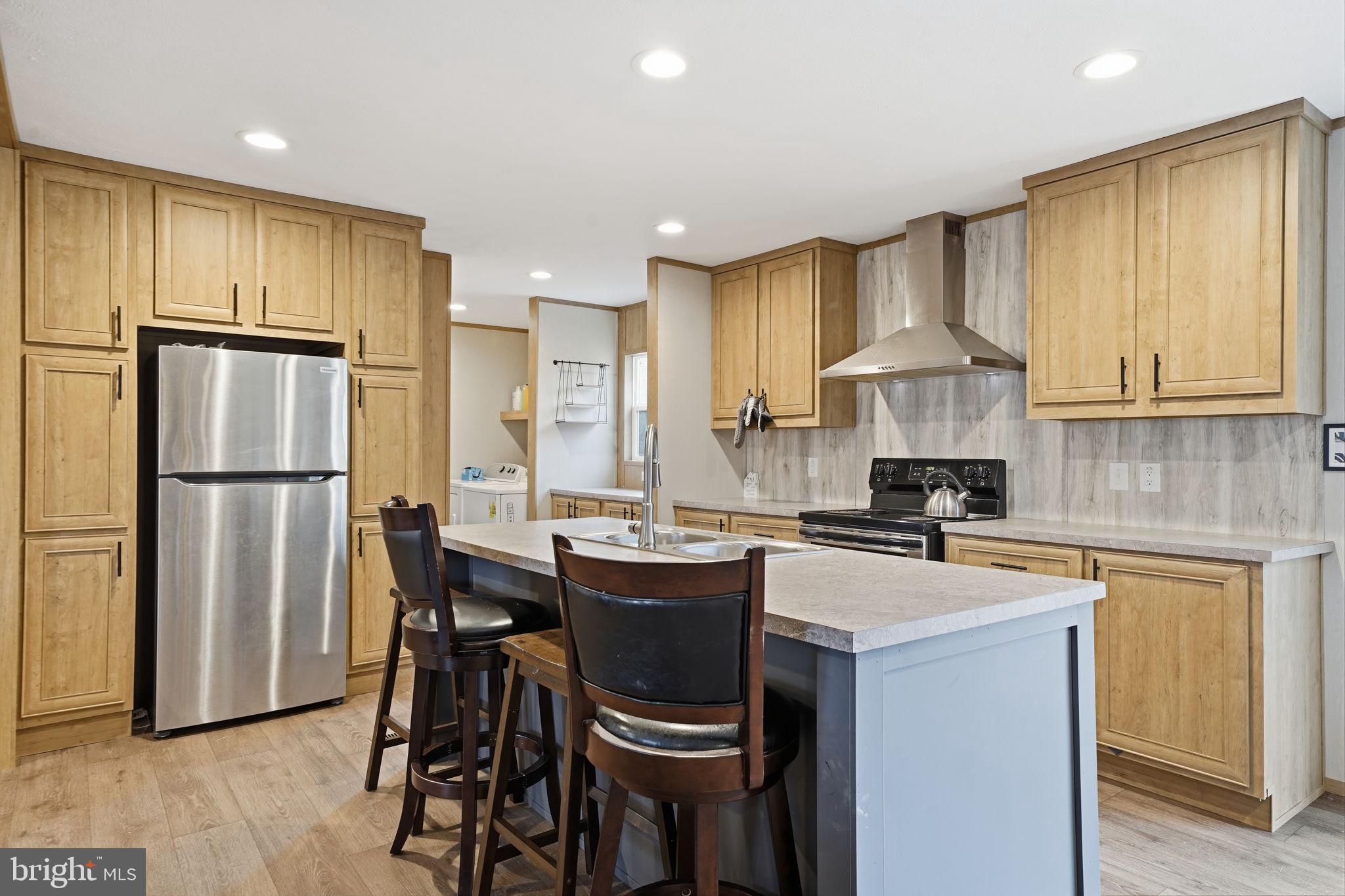 15075 Madison Run Road Gordonsville, VA 22942 - Photo 2 of 23 a kitchen with a sink a kitchen island and stainless steel appliances