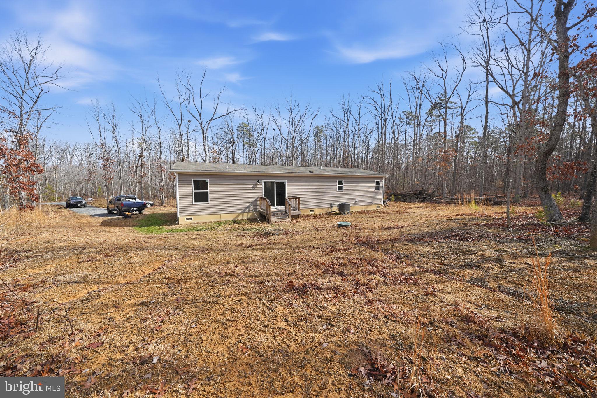 15075 Madison Run Road Gordonsville, VA 22942 - Photo 22 of 23 a front view of a house with a yard and trees