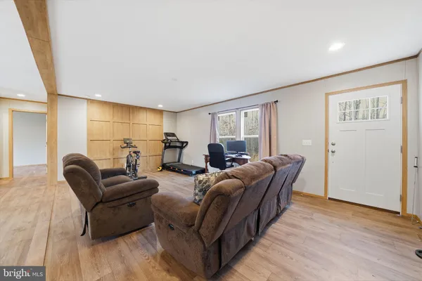 a living room with furniture and a wooden floor