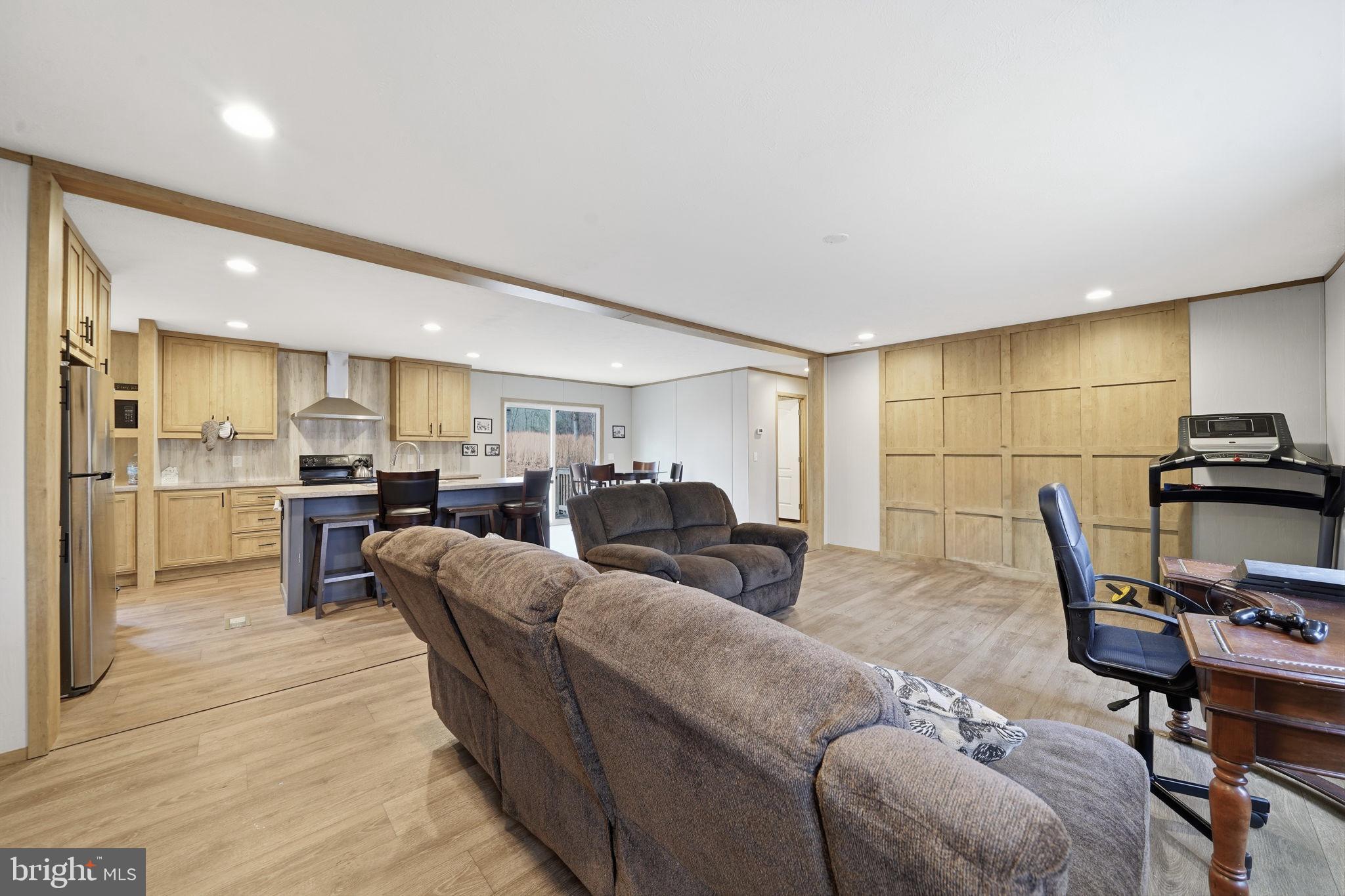 15075 Madison Run Road Gordonsville, VA 22942 - Photo 7 of 23 a living room with furniture a flat screen tv and a table