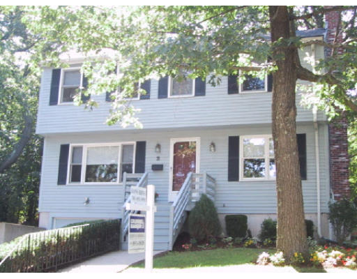 2 Virginia Road Waltham, MA 02453 - Photo 1 of 8 a front view of a house with a yard garage and outdoor seating
