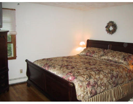 2 Virginia Road Waltham, MA 02453 - Photo 6 of 8 a bedroom with a bed and a painting on the wall