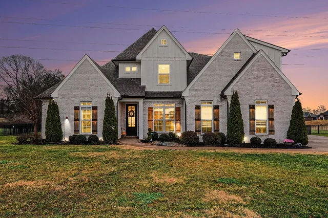 a front view of a house with a yard