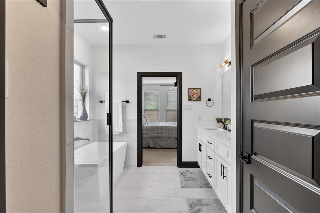 1740 Reverie Road Burleson, TX 76028 - Photo 32 of 37 a bathroom with a glass shower door and a sink