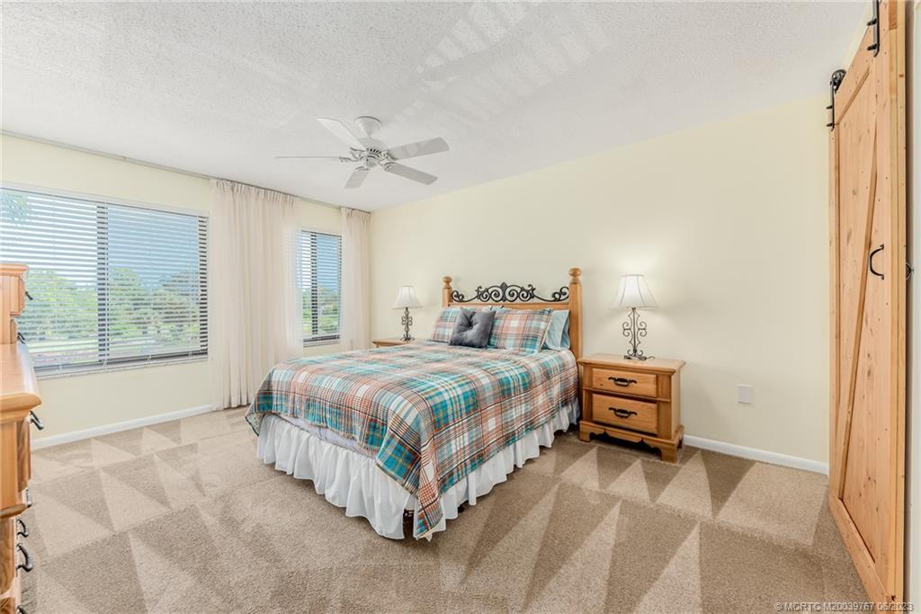 5413 Southeast Miles Grant Road, Unit G208 Stuart, FL 34997 - Photo 12 of 36 Master bedroom faces northeast for shady bright days.