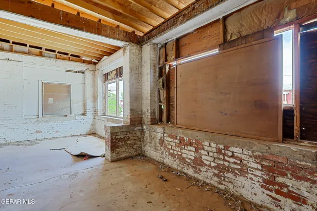 a view of a hallway with wooden walls and windows