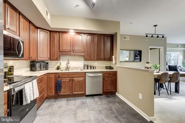 a kitchen with a sink stove and microwave