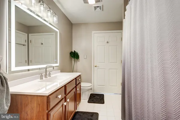 a bathroom with a sink a mirror and a shower
