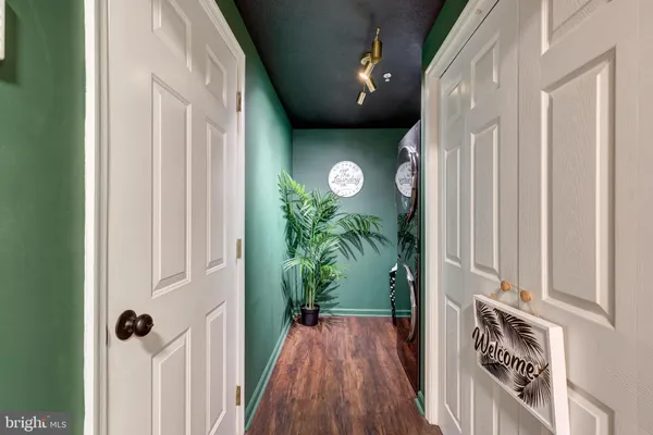 a view of a hallway with wooden floor and stairs