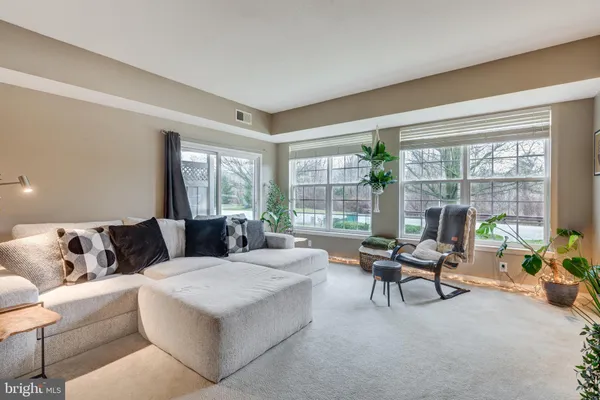 a living room with furniture and large windows