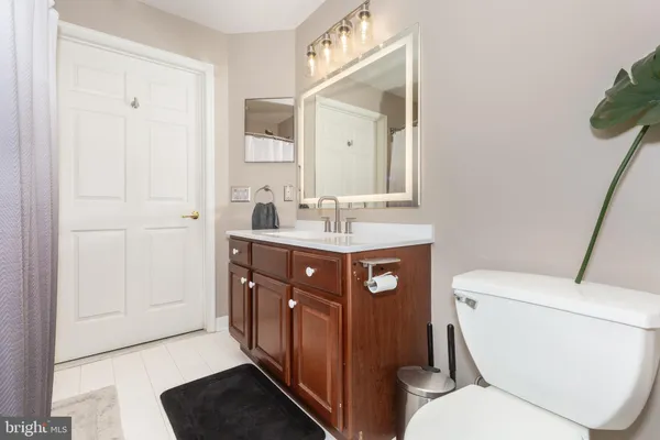 a bathroom with a toilet a sink and a mirror