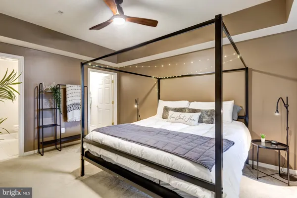 a bedroom with a bed and a chandelier