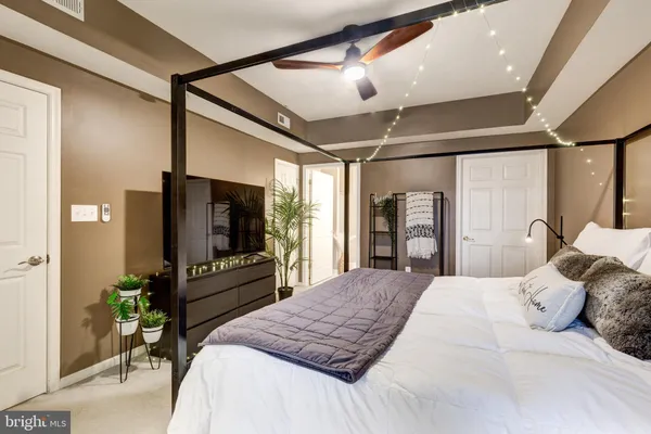 a bedroom with a large bed and a flat screen tv
