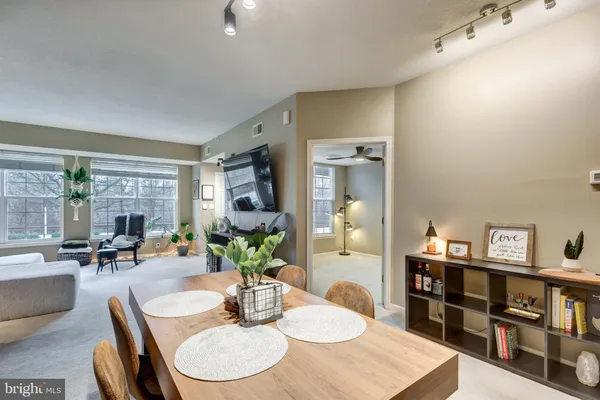 a dining room with furniture and a wooden floor