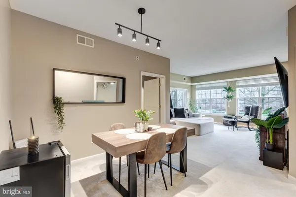 a living room with furniture a window and a flat screen tv
