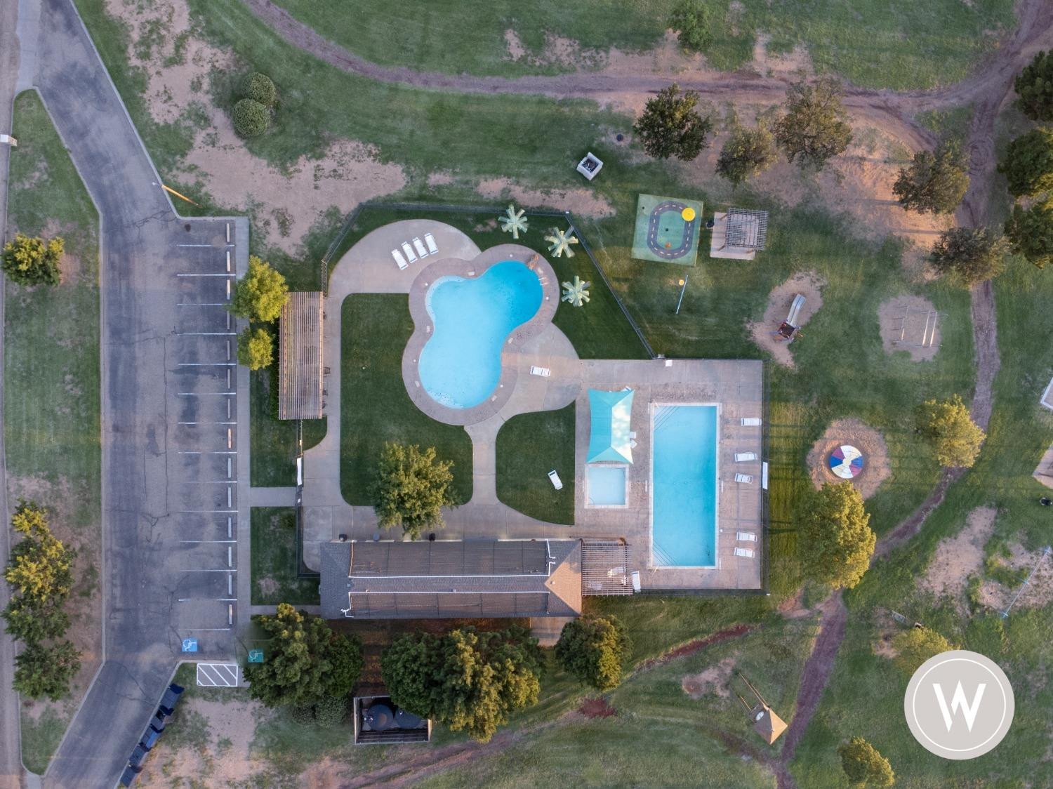 14602 County Road 1835 Lubbock, TX 79424 - Photo 4 of 5 an aerial view of a house with a swimming pool a yard and a fountain