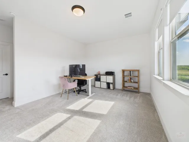 a view of a livingroom with furniture and window