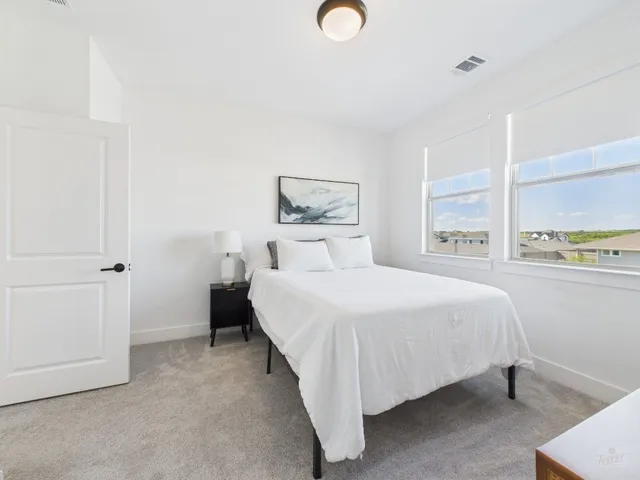 a bedroom with a bed and window