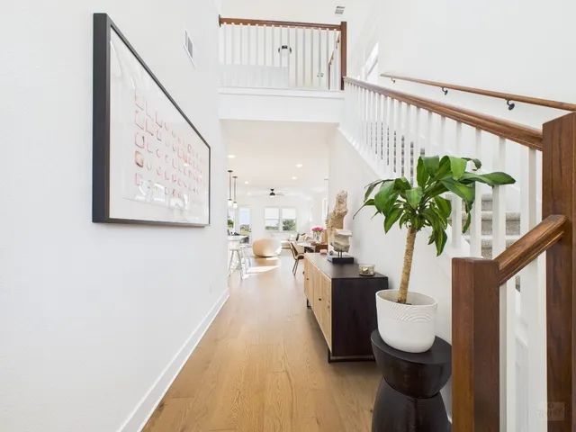 a very nice looking room with a large window with potted plants
