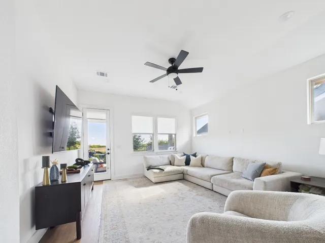 a living room with furniture and a large window
