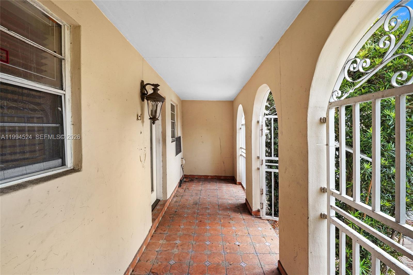 7205 West 2nd Lane Hialeah, FL 33014 - Photo 2 of 30 a view of a hallway with wooden floor and staircase