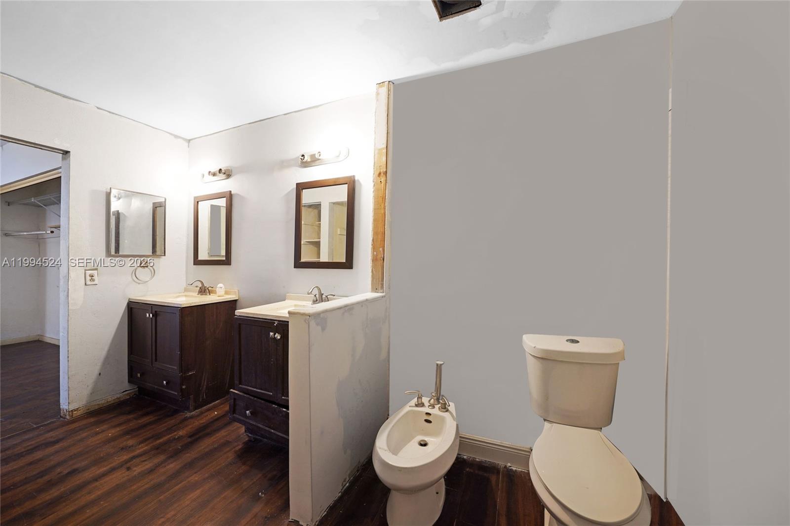 7205 West 2nd Lane Hialeah, FL 33014 - Photo 22 of 30 a bathroom with a toilet sink vanity granite and mirror