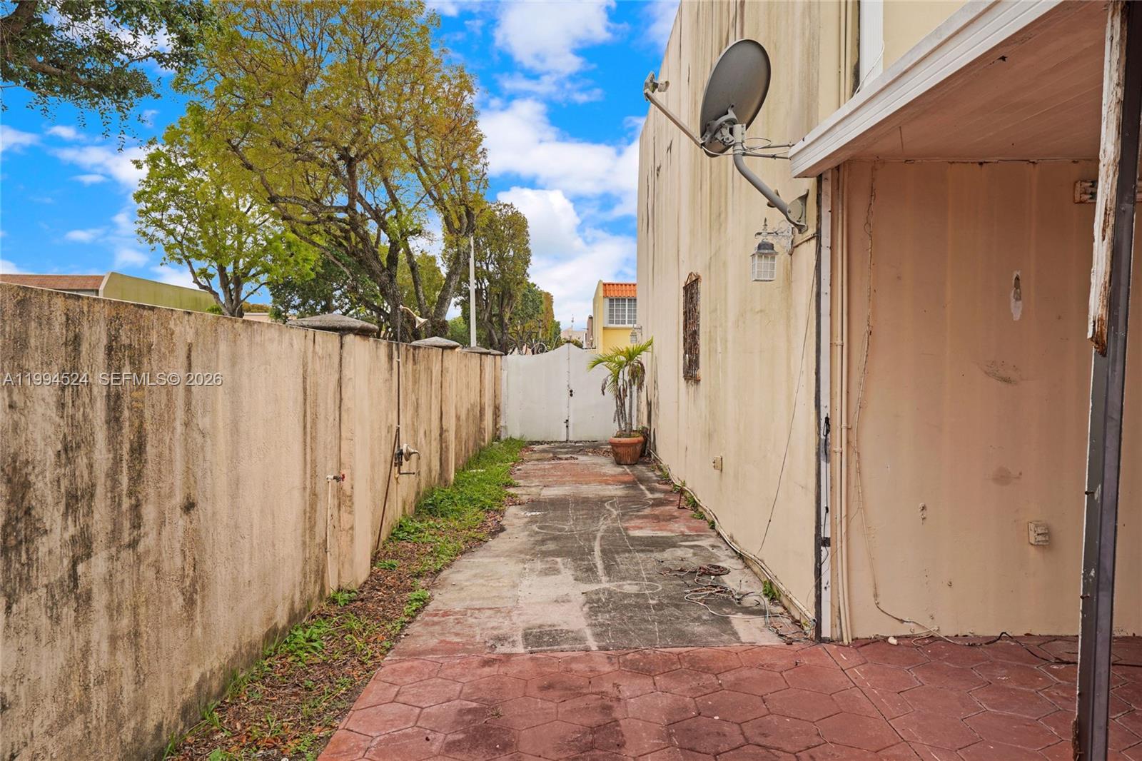 7205 West 2nd Lane Hialeah, FL 33014 - Photo 30 of 30 a view of a pathway of a building with wooden fence