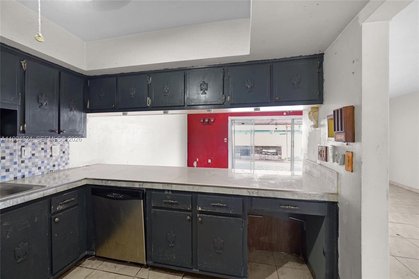 7205 West 2nd Lane Hialeah, FL 33014 - Photo 9 of 30 a kitchen with granite countertop a sink a stove and wooden cabinets