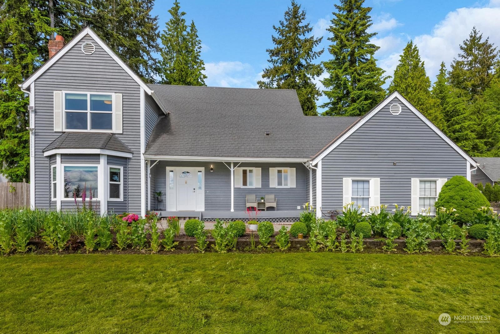 17218 3rd Avenue Southeast Bothell, WA 98012 - Photo 2 of 28 a front view of a house with a yard and trees
