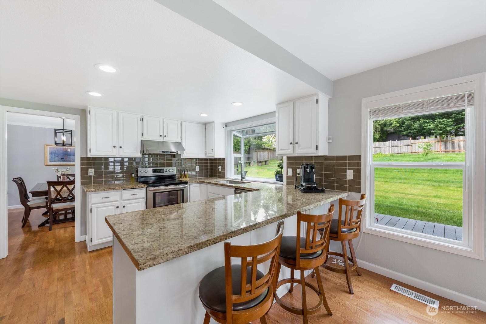17218 3rd Avenue Southeast Bothell, WA 98012 - Photo 8 of 28 a kitchen with granite countertop kitchen island a table and chairs in it