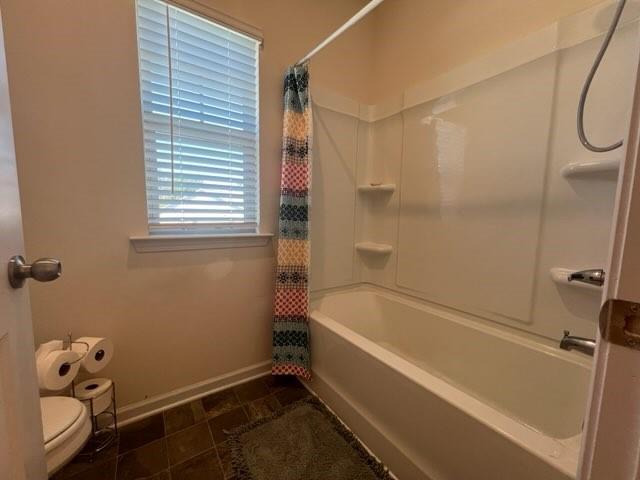 20 Pippin Place Northeast Rome, GA 30165 - Photo 21 of 25 Bathroom with shower / bath combination with curtain and dark tile patterned floors