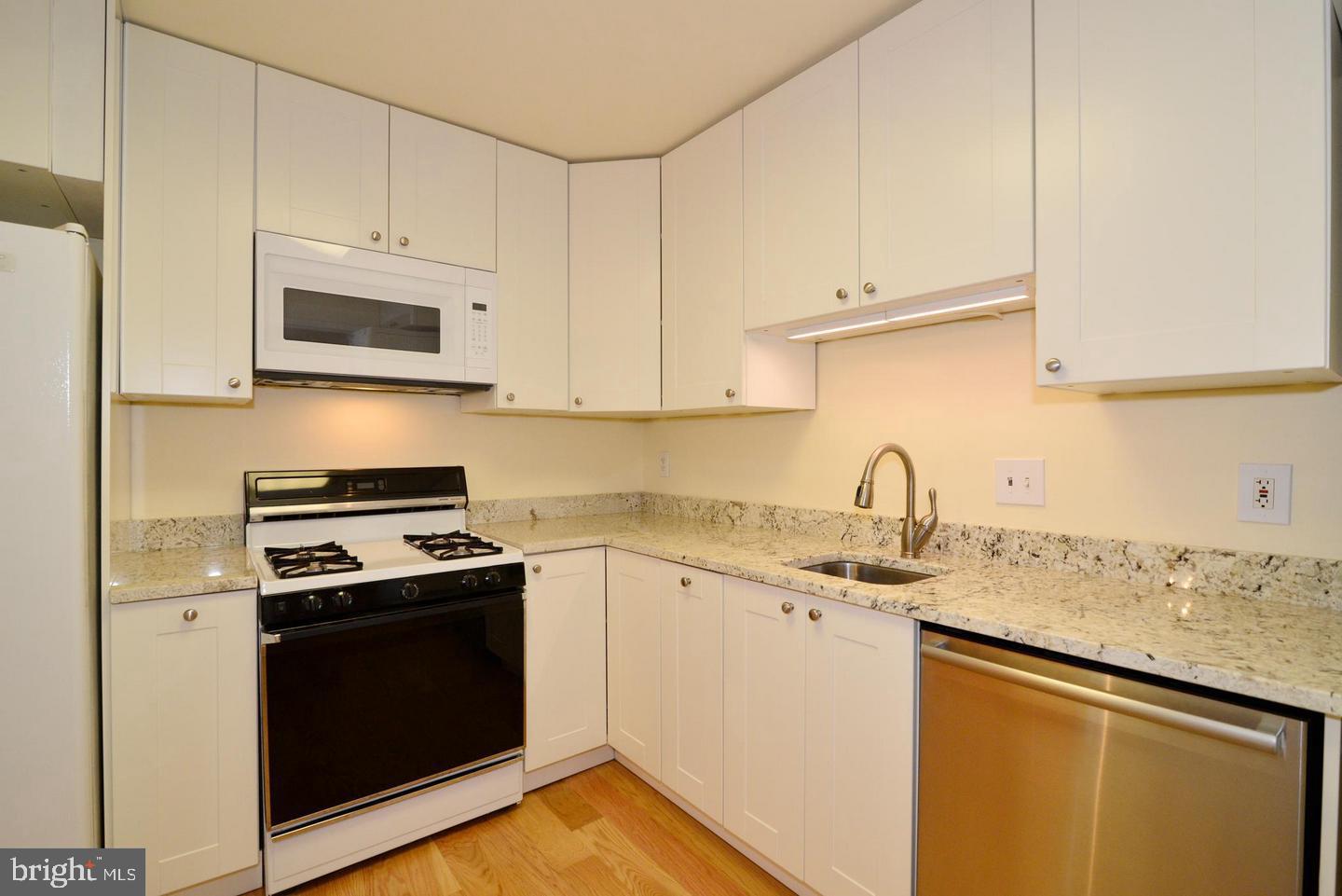 11803 Breton Court, Unit 32C Reston, VA 20191 - Photo 14 of 23 a kitchen with stainless steel appliances granite countertop a sink stove and microwave