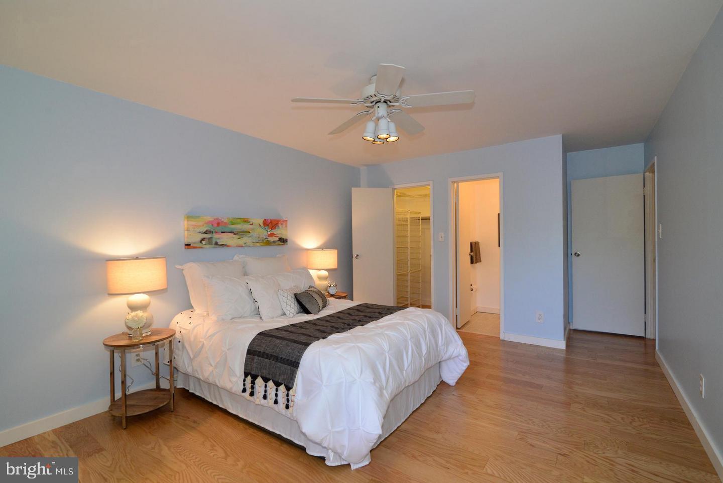 11803 Breton Court, Unit 32C Reston, VA 20191 - Photo 16 of 23 a bedroom with a bed and a chandelier