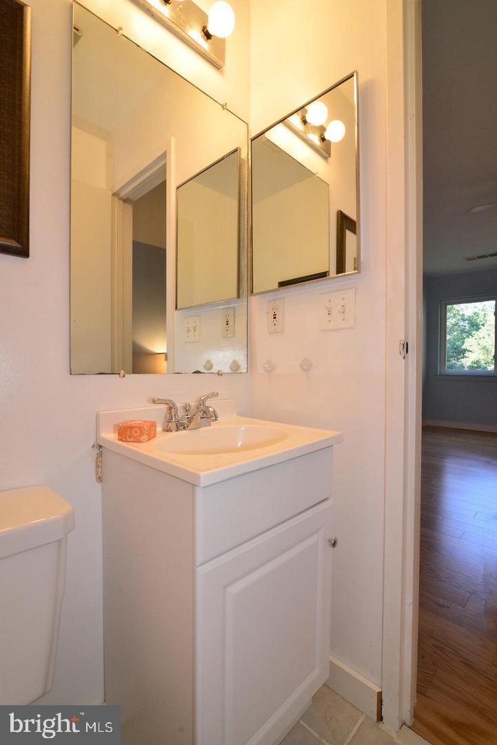 11803 Breton Court, Unit 32C Reston, VA 20191 - Photo 17 of 23 a bathroom with a sink and a mirror