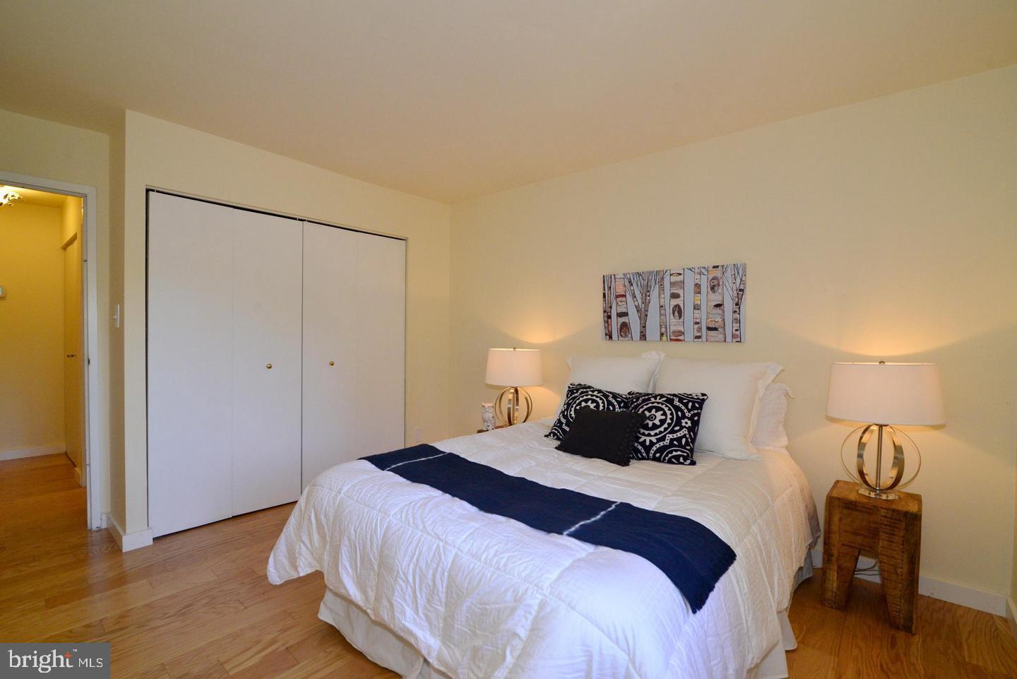 11803 Breton Court, Unit 32C Reston, VA 20191 - Photo 9 of 23 a bedroom with a bed and wooden floor