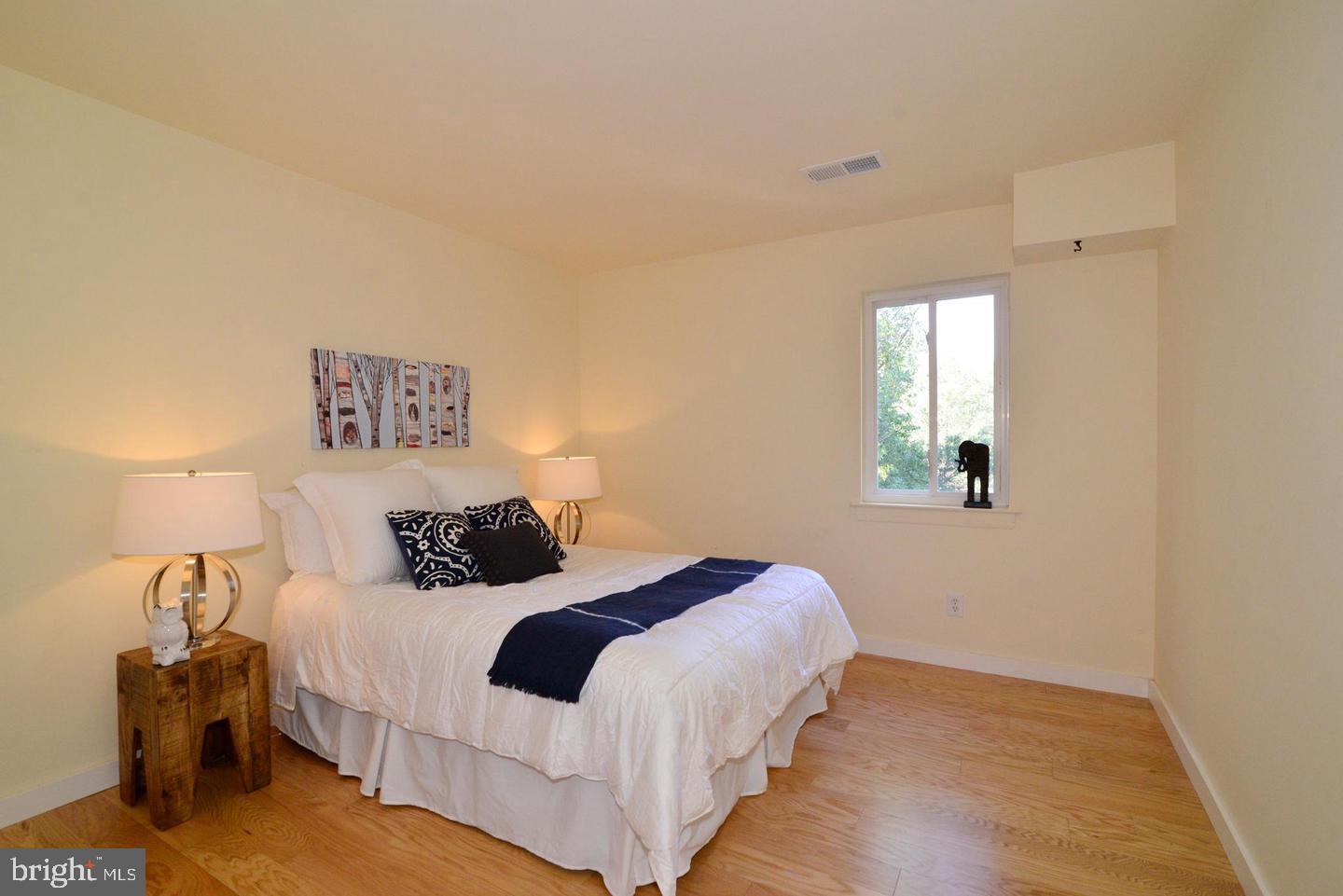 11803 Breton Court, Unit 32C Reston, VA 20191 - Photo 10 of 23 a bedroom with a bed and a lamp